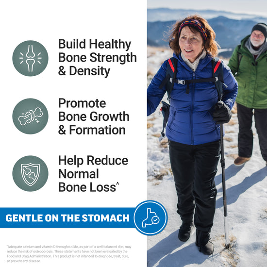 Two older hikers smiling in snowy mountains, promoting bone strength, growth, and reduced bone loss, gentle on the stomach