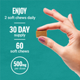 Hand holding a single caramel soft chew with text showing dosage, supply, and serving information.