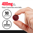 Hand holding red Longjack Tongkat Ali gummy with text showing 400mg per dose, 60 gummies, and 2 gummies per serving
