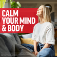 Woman smiling on a couch with sunlight shining in, next to bold text reading “Calm Your Mind & Body.”