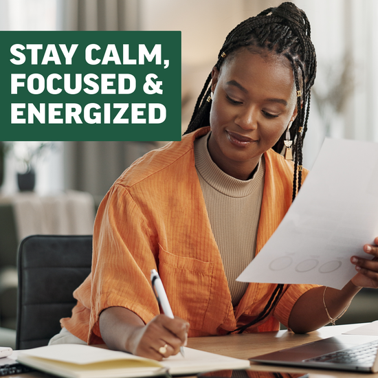 Woman writing at desk promoting calm, focused, and energized daily productivity with matcha supplement