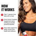 Smiling woman holding Force Factor Cranberry Concentrate bottle with How It Works instructions to take 1 capsule daily for urinary tract support
