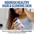 Woman smiling while holding a container of colostrum to promote hair health and glowing skin with 2000mcg biotin.