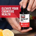 Hands opening Force Factor Alpha GPC 600mg bottle on kitchen counter with lemons and berries, promoting elevated cognitive health