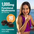 Woman smiling outdoors eating a mushroom gummy with 1,000mg functional mushrooms and 90 servings callout
