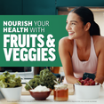 Woman smiling in kitchen with fresh vegetables promoting Force Factor Fruits & Veggies supplement for daily health
